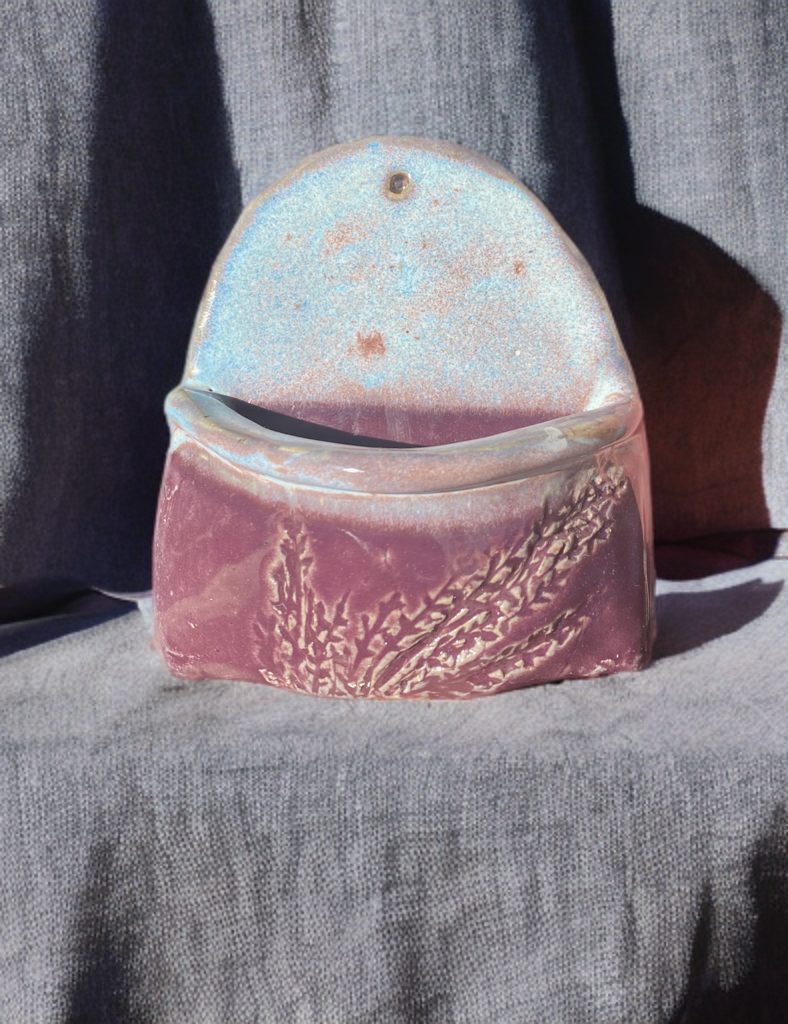 Wall pocket with opalescent blue and mauve botanical glaze